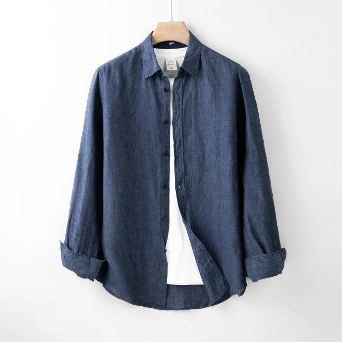 A blue shirt hanging on a white wall